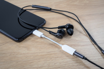 Type-c usb to headphone 3.5mm audio jack cable adapter on a smartphone