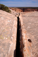 Massive crack in sandstone on a canyon rim in the Bears Ears wilderness area of Southern Utah.  