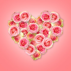 Bouquet of tea roses in the shape of a heart on a coral background. Valentine's Day.