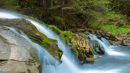 closeup small waterfall on a mountain river
