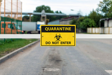 automatic barrier with a Coronavirus Warning sign, Covid-19 containment concept