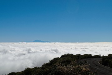 Looking at Teide from La Palma over a sea of clouds by the road