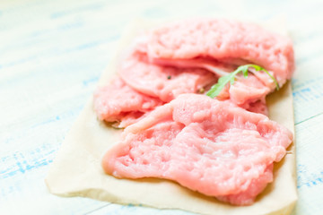 Chop meat-chicken, turkey filen light wooden background.