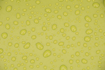Water drops on yellow background