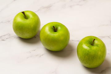 ,three green apples on a white background
