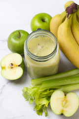 celery and fresh fruit smoothie and ingredients
