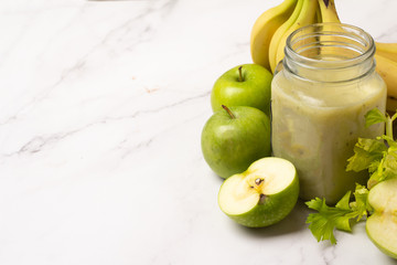 smoothie of celery and fresh fruits on a white background and place for text
