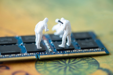 Miniature People: Worker professional checking technology inside old personal computer. maintenance concept, close up view.