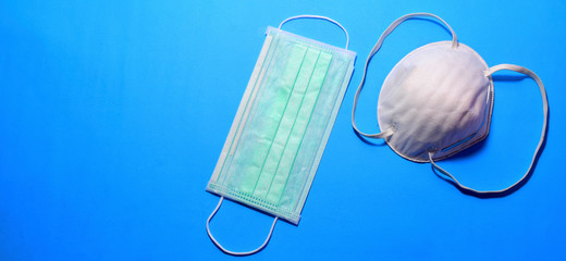 Two types of protective face masks on blue background 