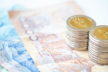 Miniature people: stack of coin and bill cash with copy space for text using as background saving, investment, money, financial, business analytics concept.