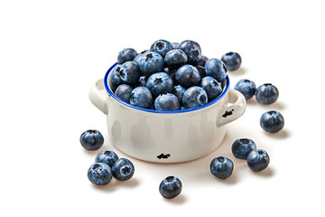 Blueberry in ceramic bowl isolated on white. Fresh blueberry closeup, healthy diet nutrition concept. Ripe organic bilberry, vegan meal. Juicy blueberries background.