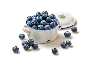 Blueberry in ceramic bowl isolated on white. Fresh blueberry closeup, healthy diet nutrition concept. Ripe organic bilberry, vegan meal. Juicy blueberries background.