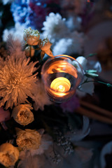 Festive decor with flowers and a candle on the table.