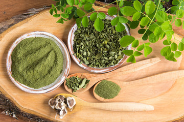 Moringa, leaves, seeds, powder on a wooden background - Moringa oleifera