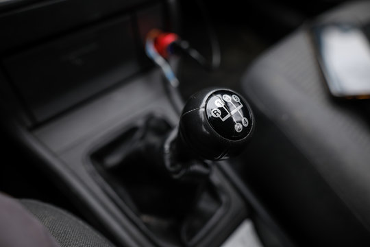 Shallow depth of field image with an old and broken gear shift knob of a manual gearbox car