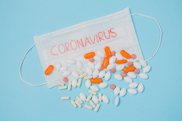 Different pills on a blue background. health and medicine. mask with text coronavirus