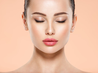 Portrait of beautiful  brunette woman with clean face, closed eyes. Closeup face of young woman...