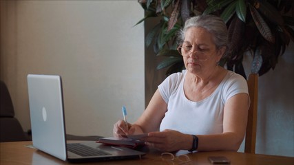 Coronavirus. Quarantine. Senior Woman finish freelance work at home