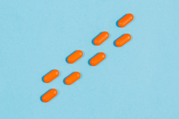 Different pills on a blue background. health and medicine