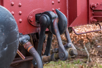 Old train carriage on rails, Red wooden train carriage. Old style hook railway coupling