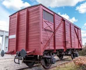 Obraz premium Old train carriage on rails, Red wooden train carriage. Old style hook railway coupling