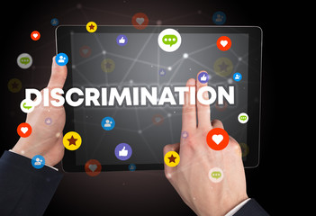 Close-up of a touchscreen with DISCRIMINATION inscription, social networking concept