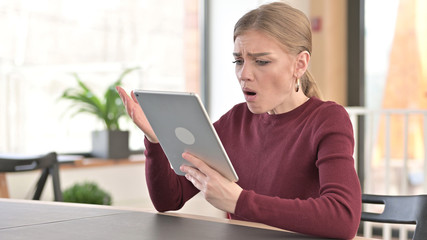 Shocked Young Woman with Failure on Tablet