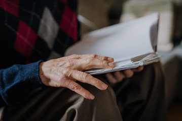 Elderly man reading book at home