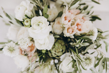 Obraz na płótnie Canvas Wedding bouquet of flowers and greenery with white ribbon
