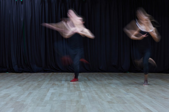 Two Ballet Dancers In A Rehearsal Studio, With Blurred Movement