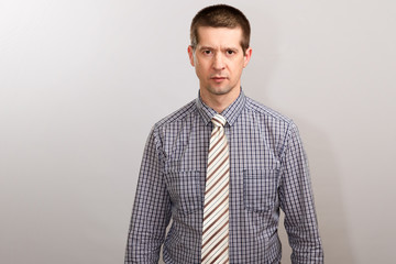 A man in a cage shirt and a wide tie. half-length portrait