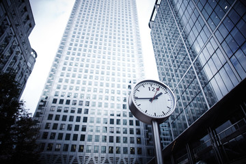 Fototapeta na wymiar City skyscrapers and modern clock in a city's finance district