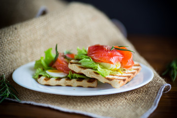 fried bread toast with salad leaves and salted red fish