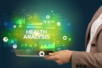 Close-up of a touchscreen with HEALTH ANALYSIS inscription, medical concept