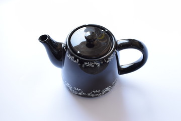 Black Teapot with white background, Selective focus on middle of image and top of the teapot