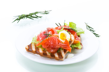 fried bread toast with salad leaves and salted red fish