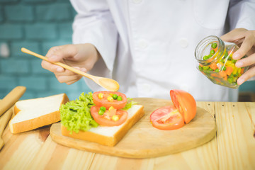 Professional Michelin Star chefs cooking  and preparing breakfast in the kitchen with care to make the food delicious and beautiful.