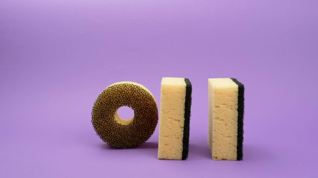 Rolling round sponge for washing dishes on a purple background.