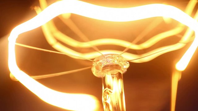 Close-up electric lamp bulb flickering