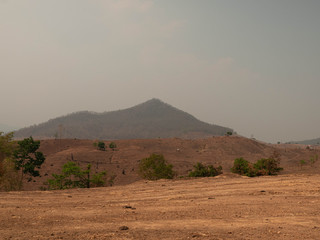 A view on the arid mountains with smog in summer in northern Thailand. Air pollution that affects health.