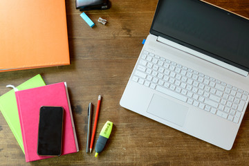 Laptop and cell phone on the table. It looks like this is my home office now.