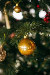 Closeup of round shiny Christmas-tree ornament. Fur tree decorations.