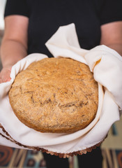 Woman holding tasty fresh homemade bread, close up
