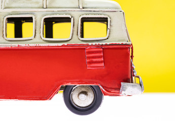 old vintage caravan toy on yellow background