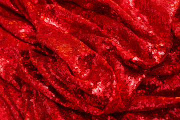 red shiny sequined pleated sequin fabric as background and texture