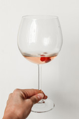 Glass of pink wine with cranberry berries
