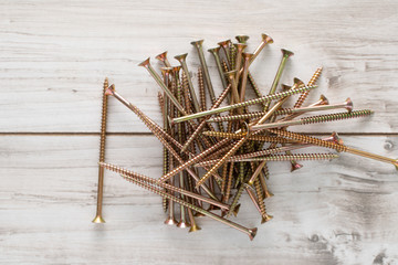 Metal big Screws on wooden background. Flat lay top view stock photo