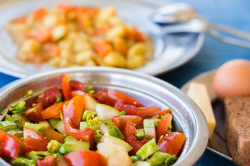 Simple Rustic Food Breakfast Set. Vegetable Salad, Stewed Potatoes with Carrots, Boiled Eggs, Bread and Butter. Stock Photo.
