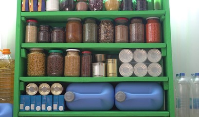 Food Stock Pantry For A Coronavirus Quarantine. Canned, boxed, and shelf-stable items. Long-term storage products on shelves in the home pantry