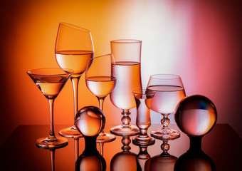 
Six glasses and glass balls on a color gradient background